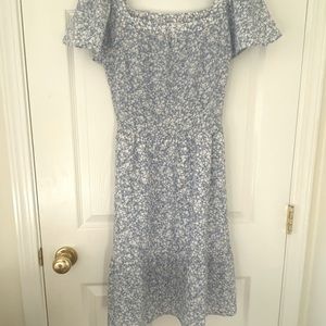 Blue sun dress with white flower pattern.